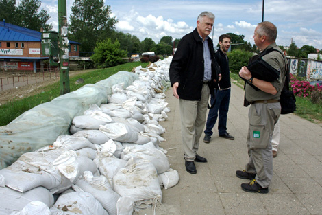 SERBIA. June 2014. Response team volunteer Torstein Nielsen (right) assessing the need in the region. Sandbags were used in an attempt to resist the floodwaters. (Colin Bradbury/ShelterBox)